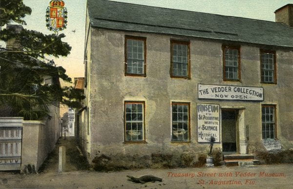 Color postcard of the two-story Vedder Museum on Treasury Street, with rows of windows and a sign above the entrance reading “The Vedder Collection Now Open.”